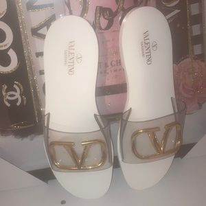 Valentino Garavani sandals with white sole and gold logo.